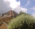 A feature eyebrow dormer in a hipped roof house